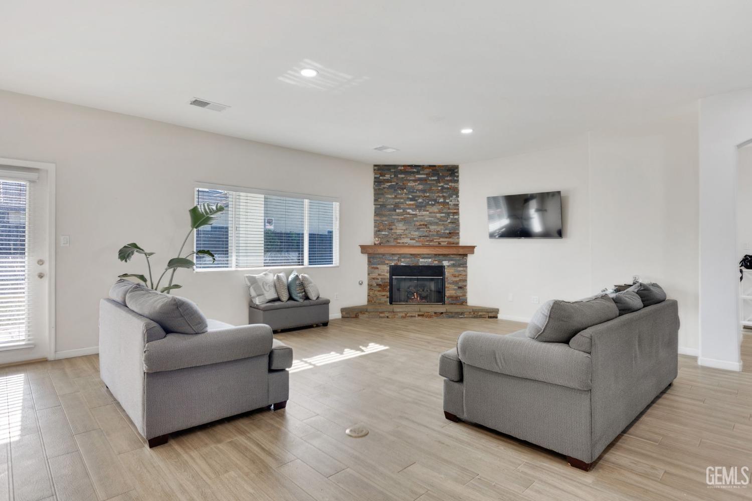 Undisclosed Address Bakersfield, CA 93312 - Photo 11 of 45 a living room with furniture and a fireplace