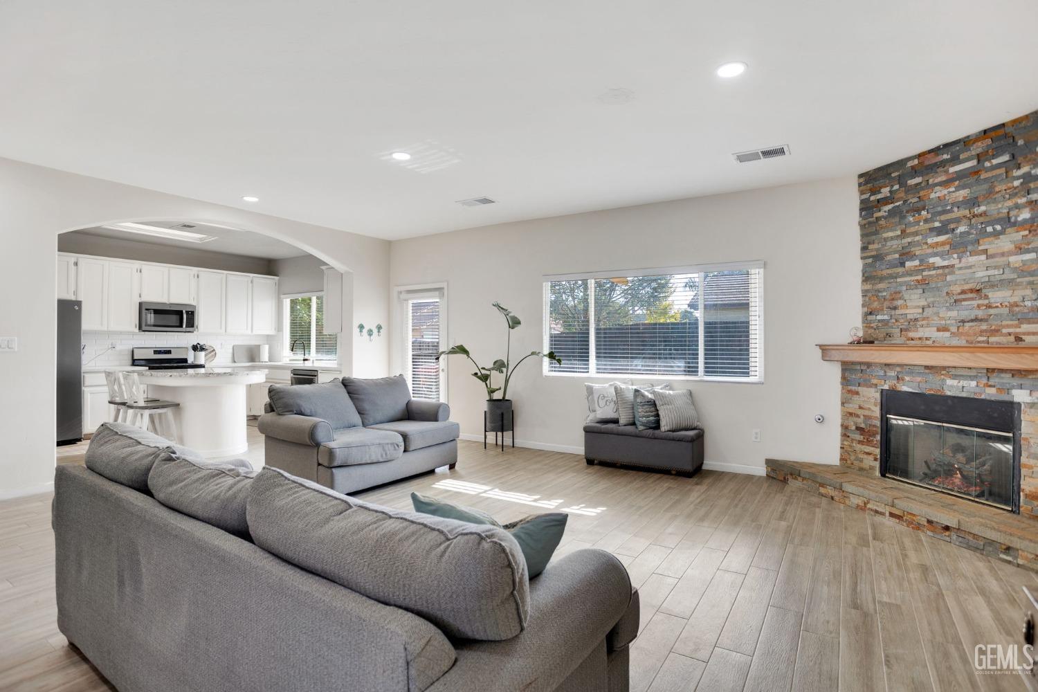 Undisclosed Address Bakersfield, CA 93312 - Photo 15 of 45 a living room with furniture and a fireplace