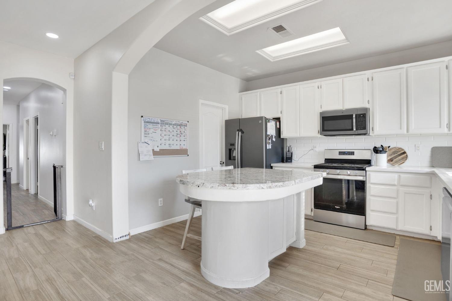 Undisclosed Address Bakersfield, CA 93312 - Photo 18 of 45 a kitchen with a white appliances a sink and a refrigerator