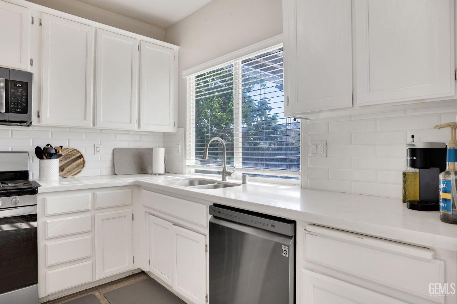 Undisclosed Address Bakersfield, CA 93312 - Photo 19 of 45 a kitchen with appliances cabinets and a sink