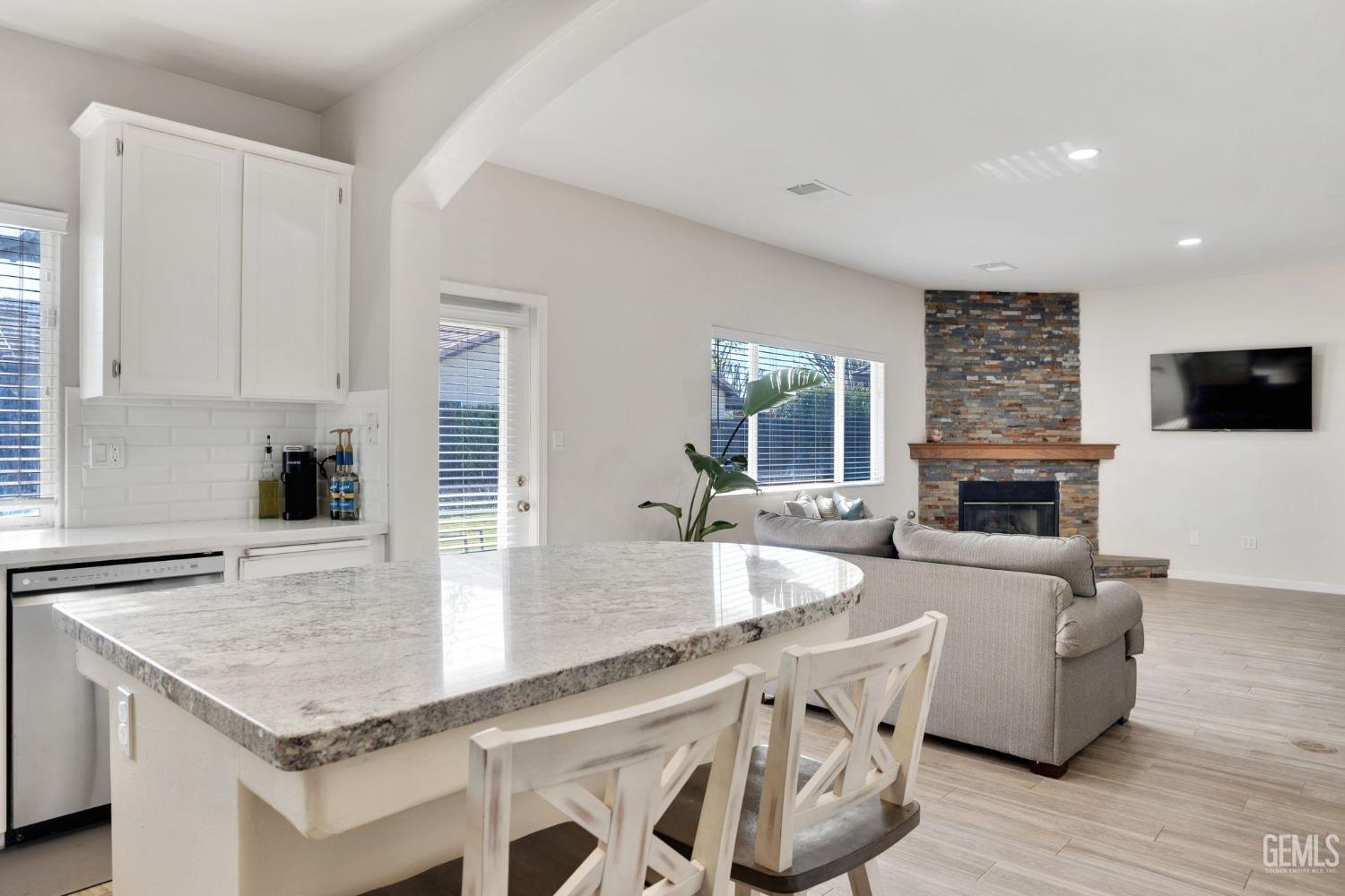Undisclosed Address Bakersfield, CA 93312 - Photo 20 of 45 a kitchen with granite countertop stainless steel appliances a stove sink and microwave