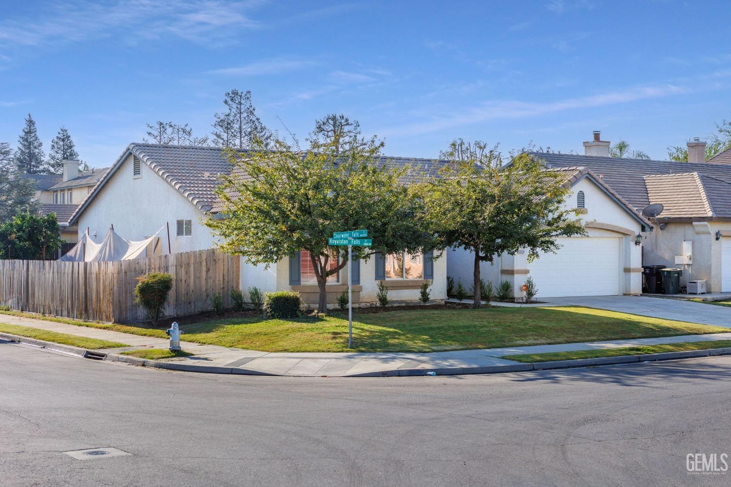Undisclosed Address Bakersfield, CA 93312 - Photo 2 of 45 a front view of a house with a yard and garage
