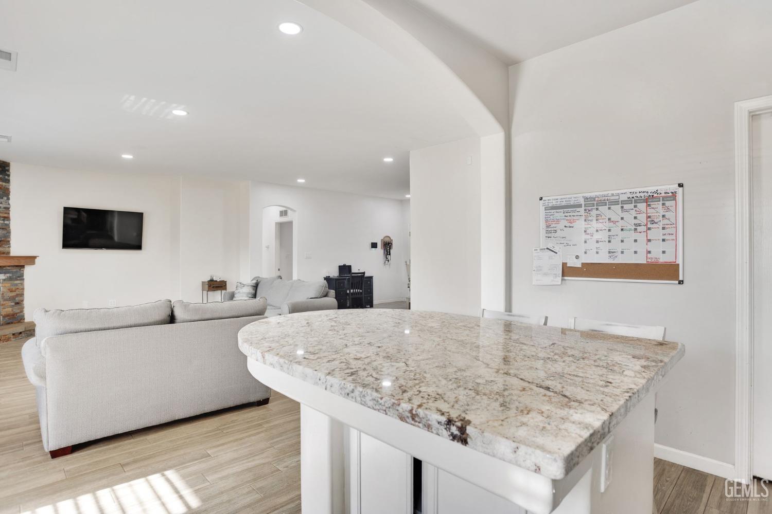 Undisclosed Address Bakersfield, CA 93312 - Photo 21 of 45 a living room with kitchen island furniture and a flat screen tv