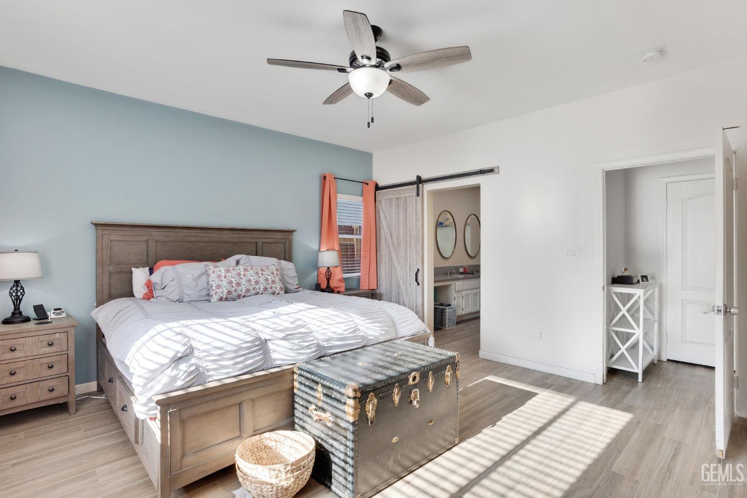 Undisclosed Address Bakersfield, CA 93312 - Photo 25 of 45 a bedroom with a bed and a chandelier