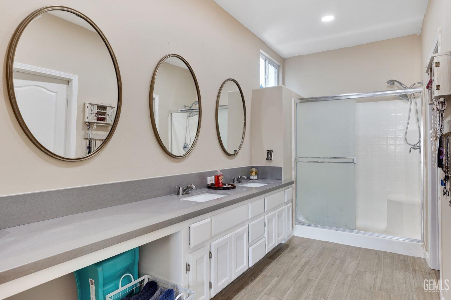 Undisclosed Address Bakersfield, CA 93312 - Photo 26 of 45 a bathroom with a double vanity sink and a mirror