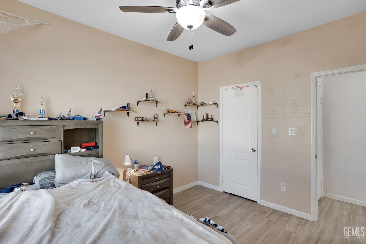 Undisclosed Address Bakersfield, CA 93312 - Photo 30 of 45 a bedroom with a bed and wooden floor