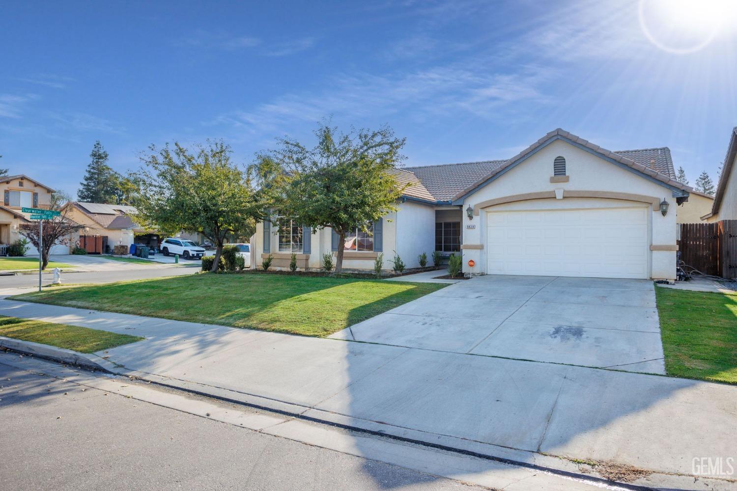 Undisclosed Address Bakersfield, CA 93312 - Photo 3 of 45 a front view of a house with a yard and garage