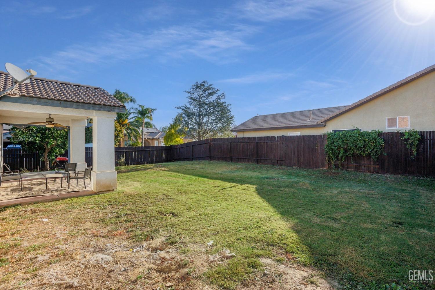 Undisclosed Address Bakersfield, CA 93312 - Photo 40 of 45 a view of a backyard with plants and large tree