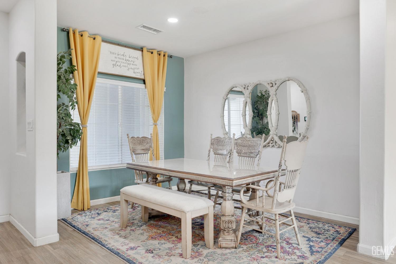 Undisclosed Address Bakersfield, CA 93312 - Photo 9 of 45 a view of a dining room with furniture and wooden floor