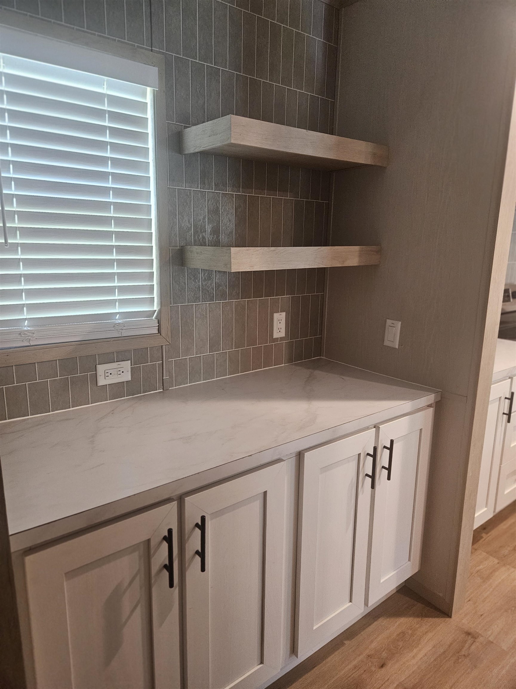 75 Pittman Road, Unit ROAD Somerville, TN 38068 - Photo 12 of 26 Built-in coffee bar with flat-panel doors and black hardware, complemented by light-toned countertops