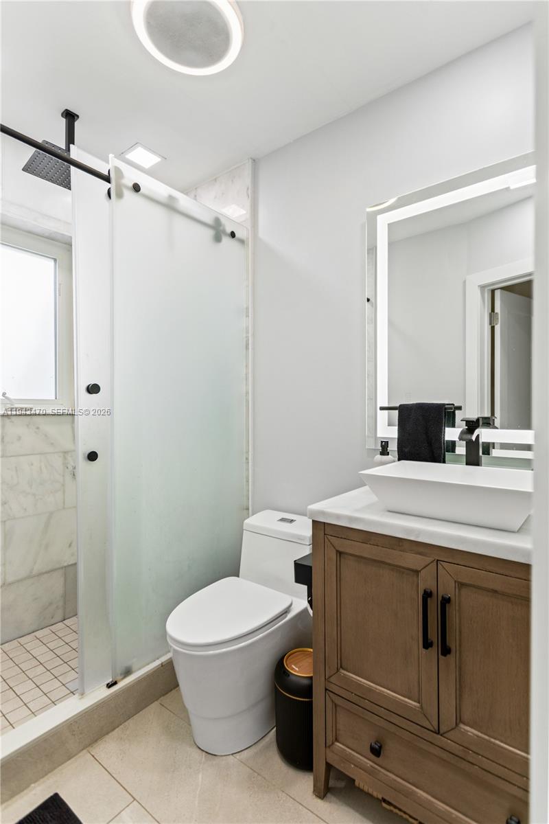 2498 Southwest 19th Terrace Miami, FL 33145 - Photo 11 of 25 a bathroom with a sink a toilet and shower