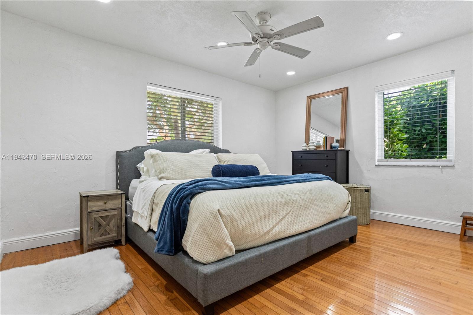 2498 Southwest 19th Terrace Miami, FL 33145 - Photo 17 of 25 a spacious bedroom with two beds and a chandelier