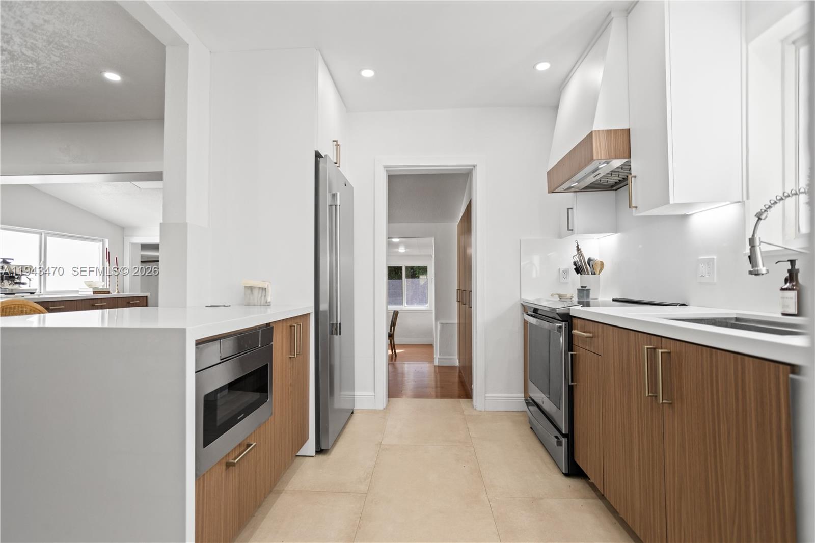2498 Southwest 19th Terrace Miami, FL 33145 - Photo 8 of 25 a kitchen with cabinets and stainless steel appliances