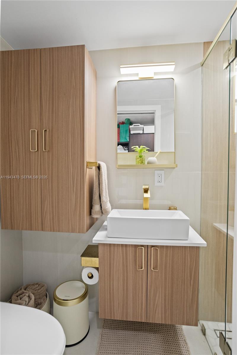 2498 Southwest 19th Terrace Miami, FL 33145 - Photo 9 of 25 a bathroom with a sink a toilet and mirror