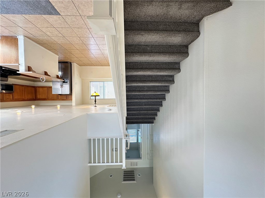 7305 Prussian Green Street Las Vegas, NV 89139 - Photo 23 of 23 An open floorplan seamlessly connects the well-appointed kitchen to the adjacent living spaces, illuminated by natural light.