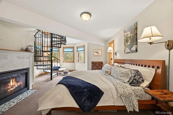 a bedroom with a bed and a fireplace
