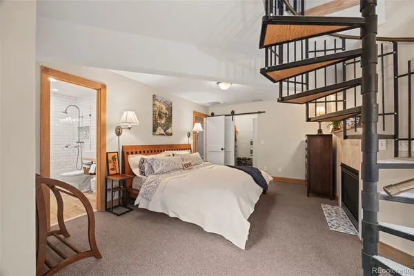 a bedroom with a bed a book shelf and a lots of books