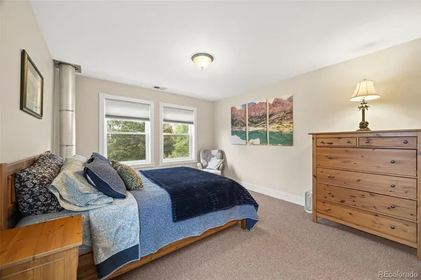 a spacious bedroom with a bed and window
