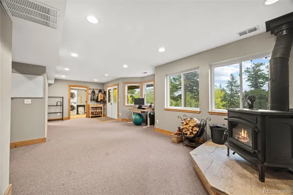 a view of a livingroom with furniture hardwood floor and a fireplace