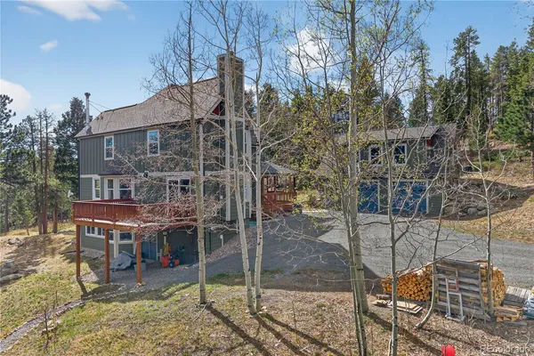 a view of house with a yard and sitting area