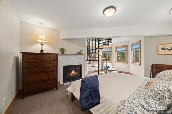 a spacious bedroom with a bed and large windows
