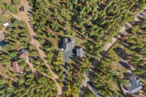 an aerial view of a house with a yard