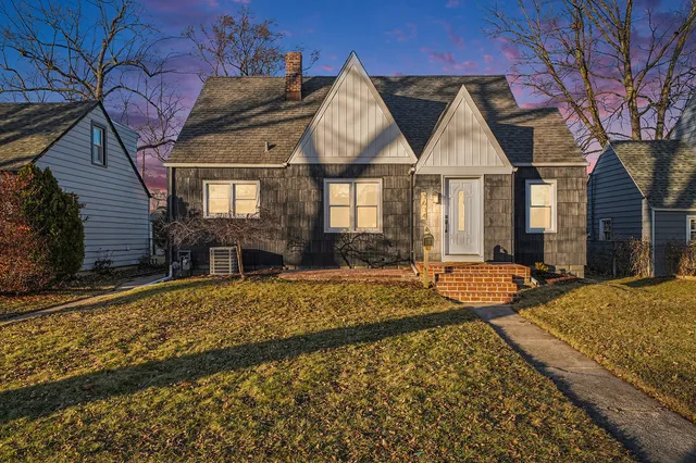 a front view of house with yard outdoor seating and barbeque oven