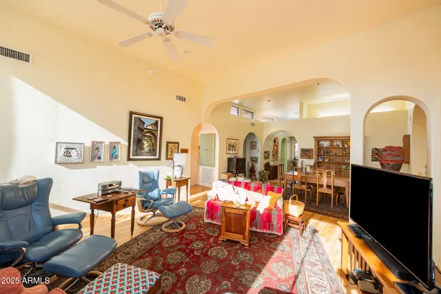 a living room with furniture and dining table
