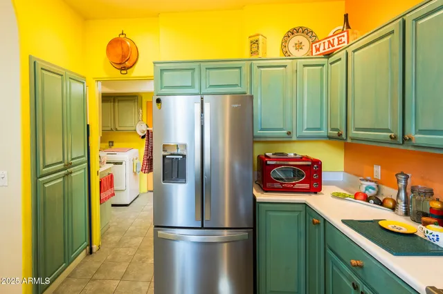 a kitchen with stainless steel appliances granite countertop a refrigerator and a stove top oven