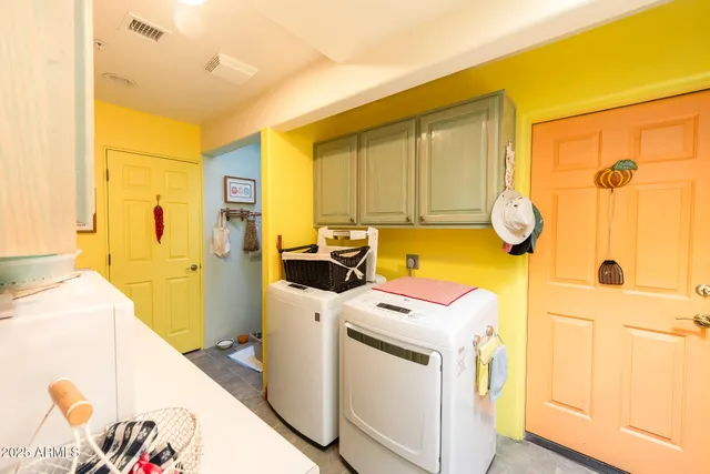 a view of washer and dryer with a kitchen view