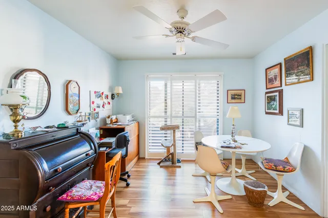 a living room with furniture a rug potted plant and a large window