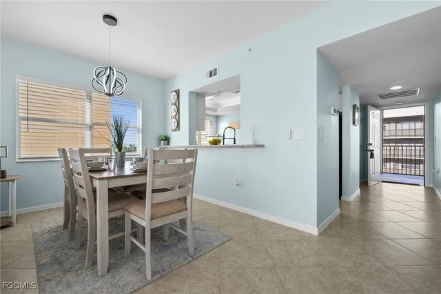 a living room with a table and chairs
