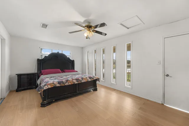 a bedroom with a bed and a ceiling fan