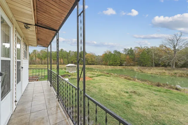 a view of a balcony with yard