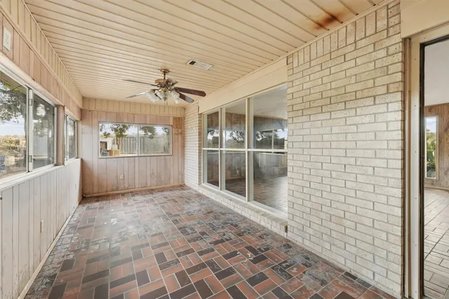 a view of a porch with a table and chairs