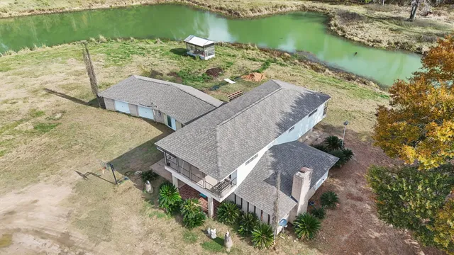 an aerial view of a house with a lake view