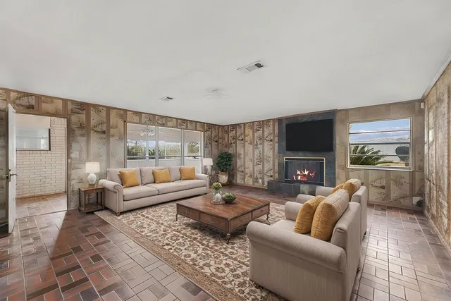 a living room with furniture fireplace and a flat screen tv