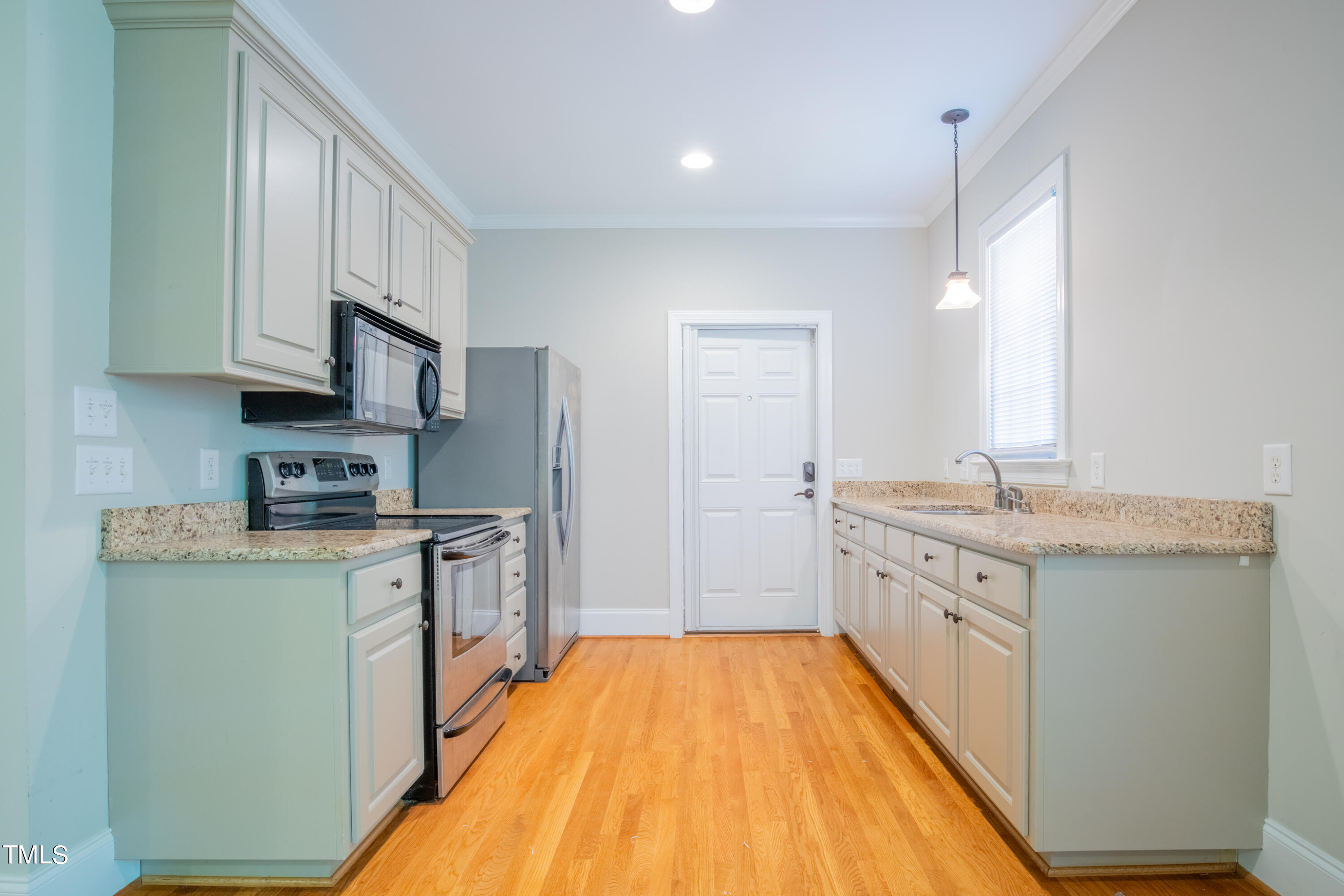 3308 Tall Tree Place Raleigh, NC 27607 - Photo 32 of 34 a kitchen with stainless steel appliances granite countertop a sink stove and refrigerator