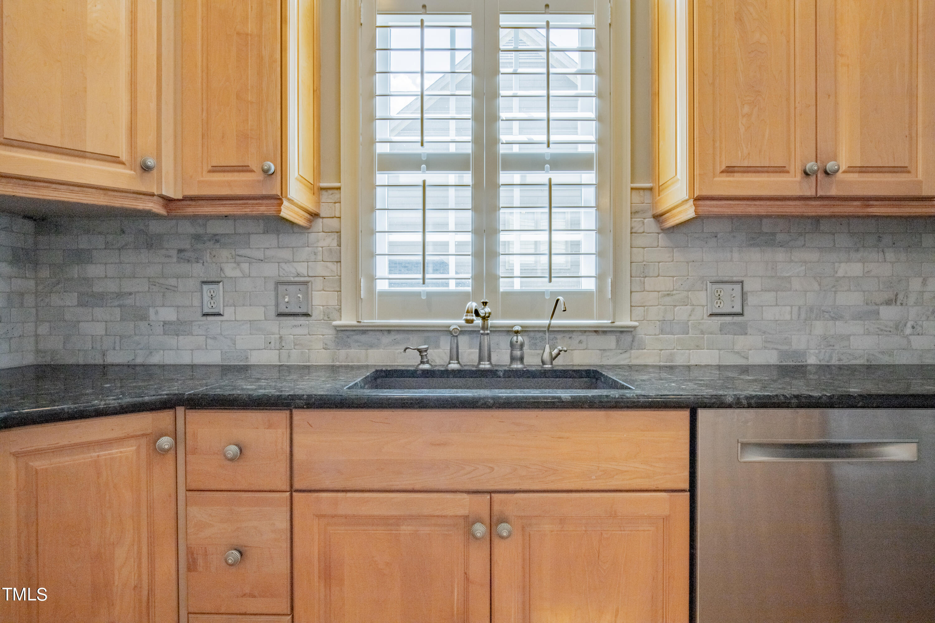 3308 Tall Tree Place Raleigh, NC 27607 - Photo 9 of 34 a kitchen with granite countertop white cabinets and a window