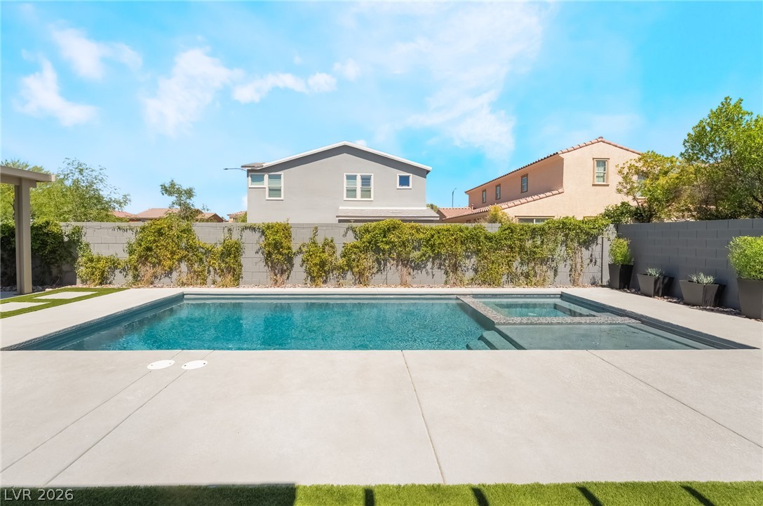 2166 Trivero Street Henderson, NV 89044 - Photo 40 of 61 A tranquil private pool with an integrated spa awaits, perfect for relaxation and outdoor enjoyment.