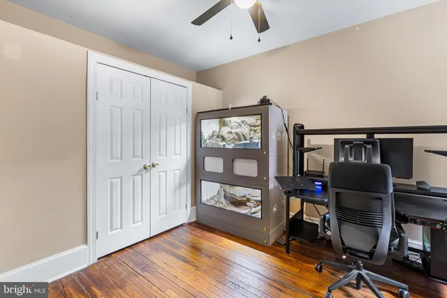 a view of workspace with wooden floor windows