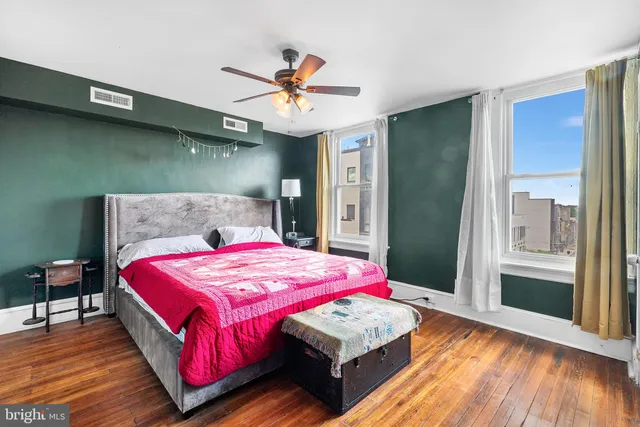 a bedroom with a bed and a lamp