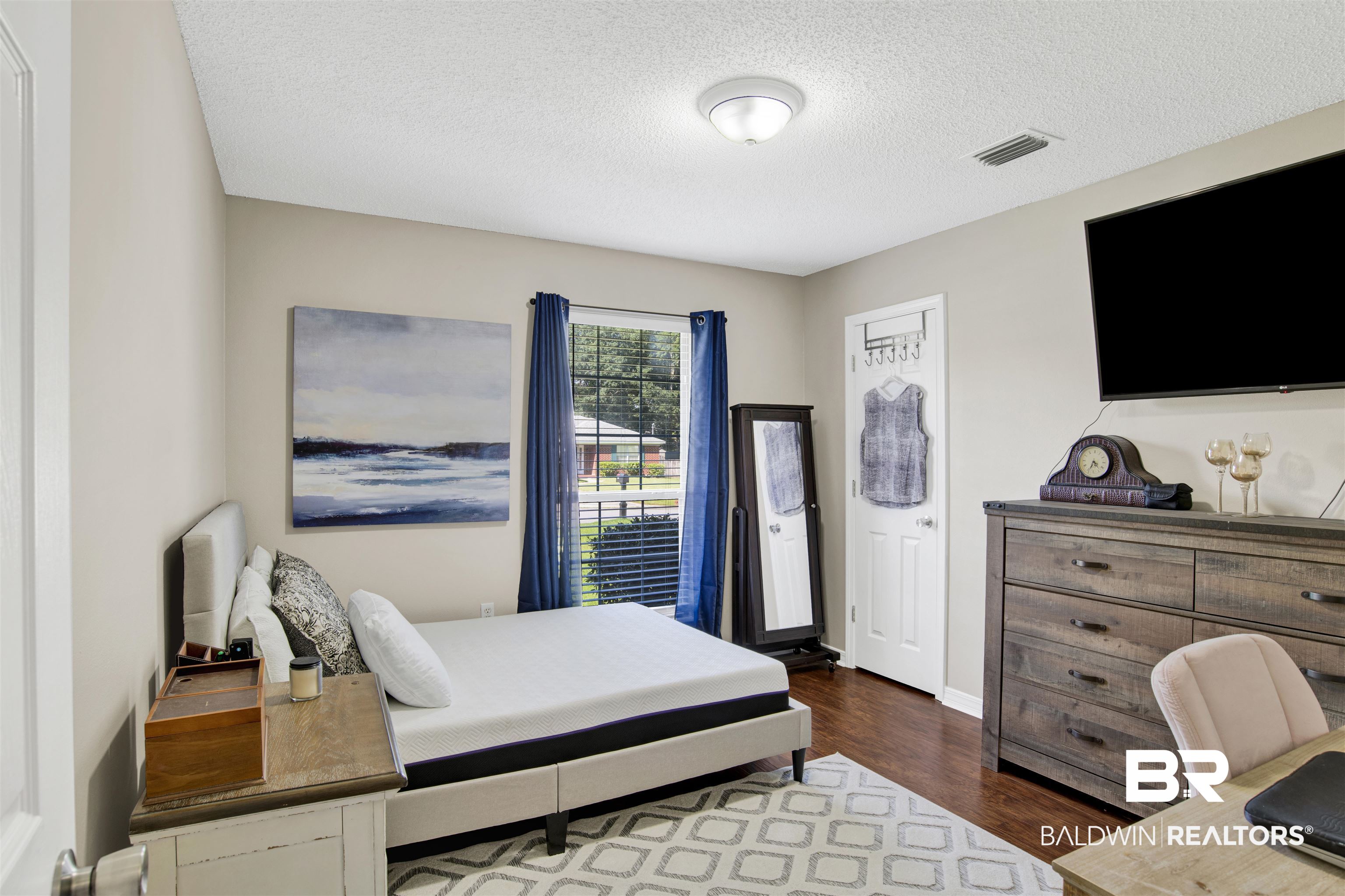 6281 Woodside Drive Theodore, AL 36582 - Photo 14 of 17 Bedroom with dark wood finished floors and a textured ceiling