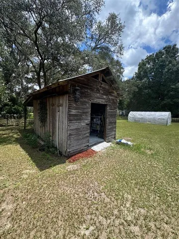 a view of backyard with wooden fence