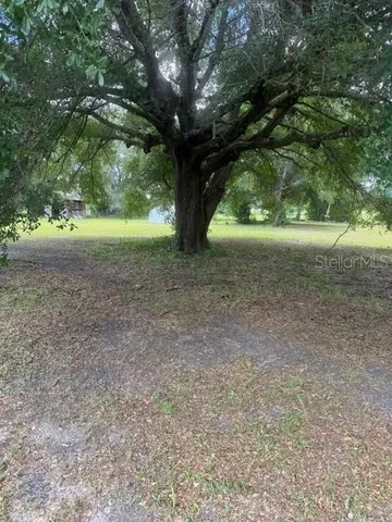 a view of outdoor space with deck and yard