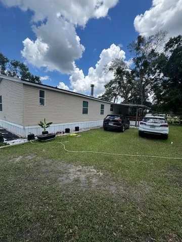 a view of a house with a backyard porch and sitting area
