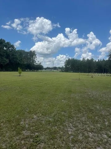a view of a lake with a house in the background