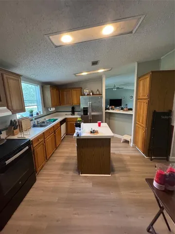 a large kitchen with stainless steel appliances kitchen island granite countertop a large counter top stainless steel appliances and cabinets