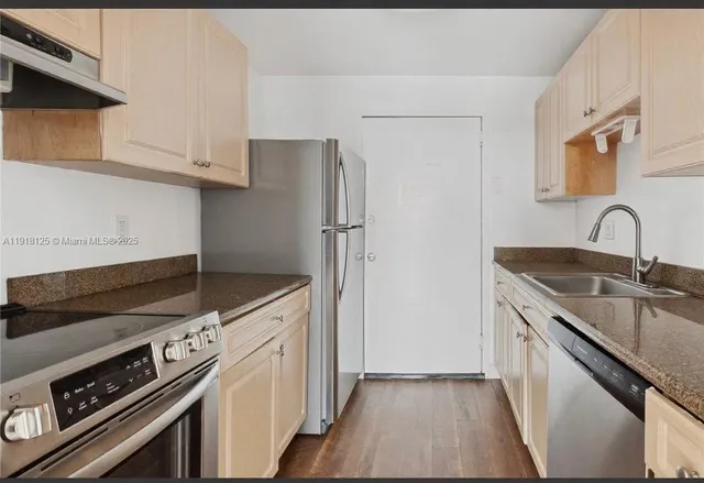 a kitchen with a sink stove and refrigerator