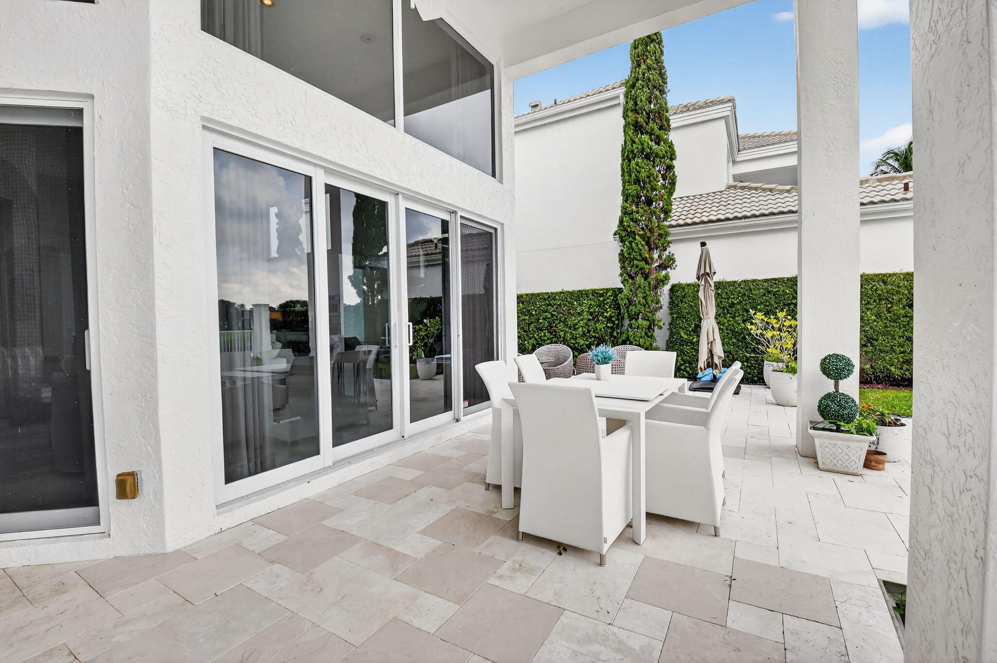2563 Northwest 63rd Street Boca Raton, FL 33496 - Photo 39 of 65 a view of a patio with couches and potted plants